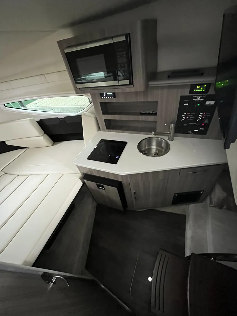 Slide: The Image of Interior of 2022 Regal 26XO boat with kitchenette and seating area. - 6