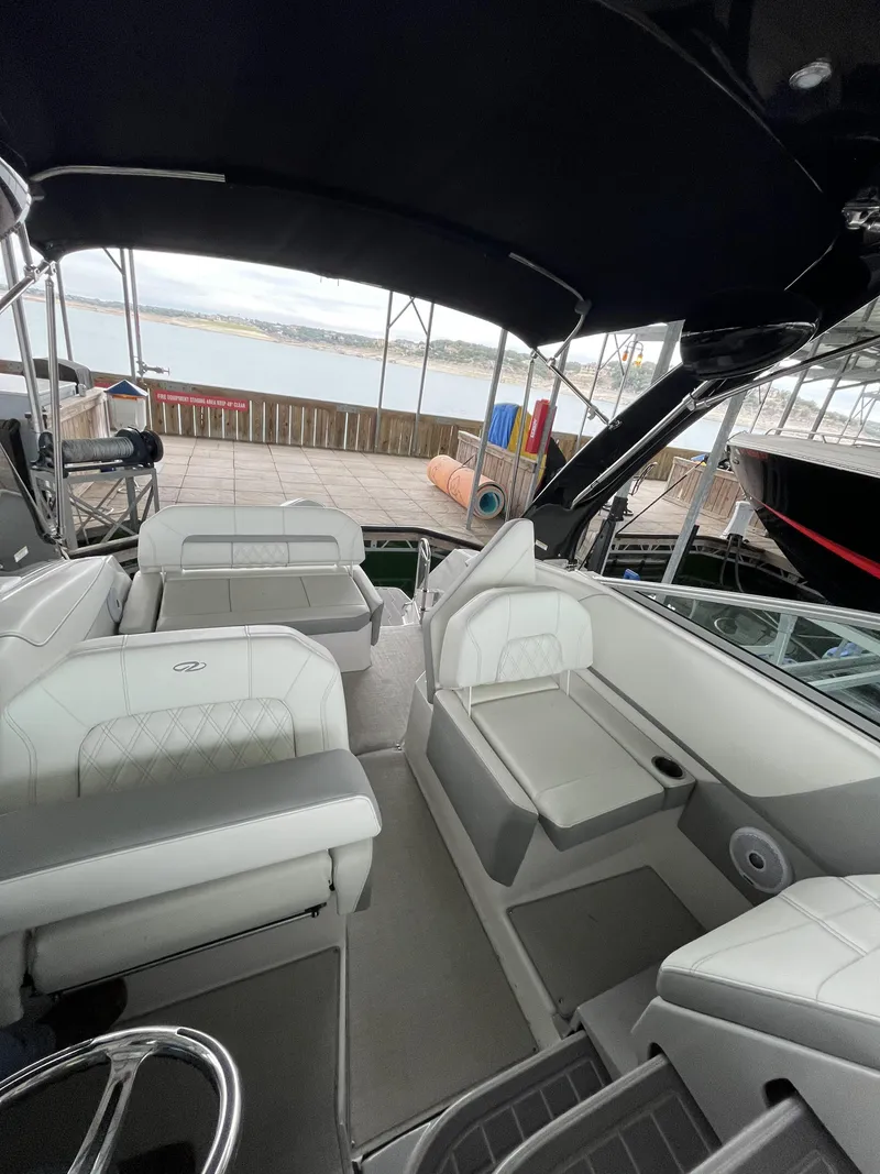 Slide: The Image of 2022 Regal 26XO boat interior with white seating and black canopy. - 8