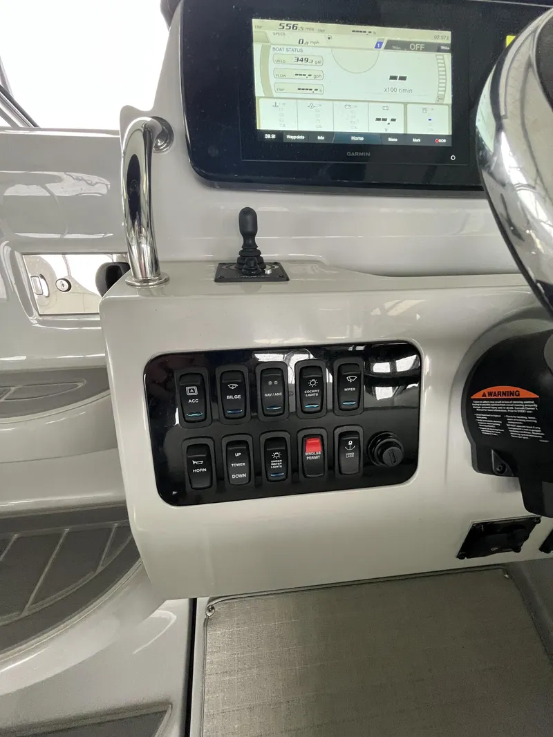 Slide: The Image of Control panel of 2022 Regal 26XO boat with switches and display screen. - 9