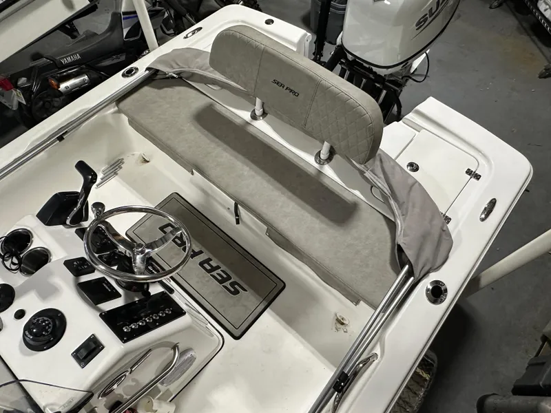 Slide: The Image of 2024 Sea Pro 172 Bay boat interior with steering wheel and seating. - 19