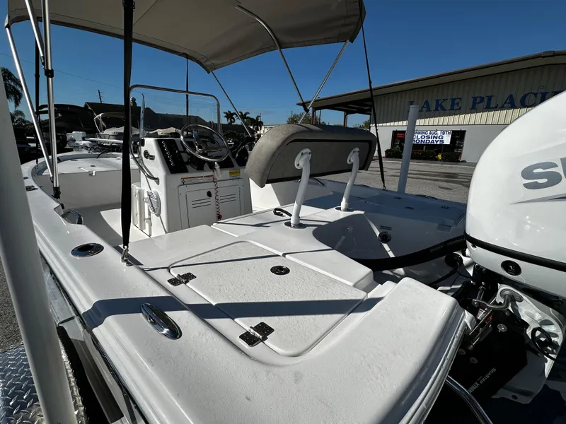 Slide: The Image of 2024 Sea Pro 172 Bay boat with canopy and motor, parked outdoors. - 22