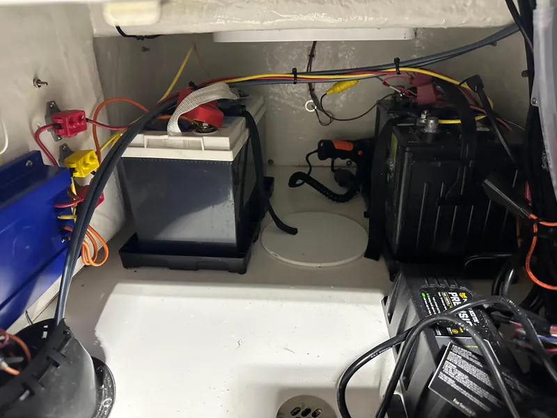 Slide: The Image of 2024 Sea Pro 172 Bay boat battery compartment with wiring and components. - 23