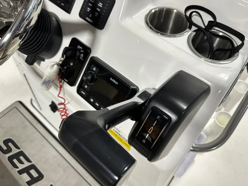 Slide: The Image of 2024 Sea Pro 172 Bay boat console with controls and cup holders. - 6