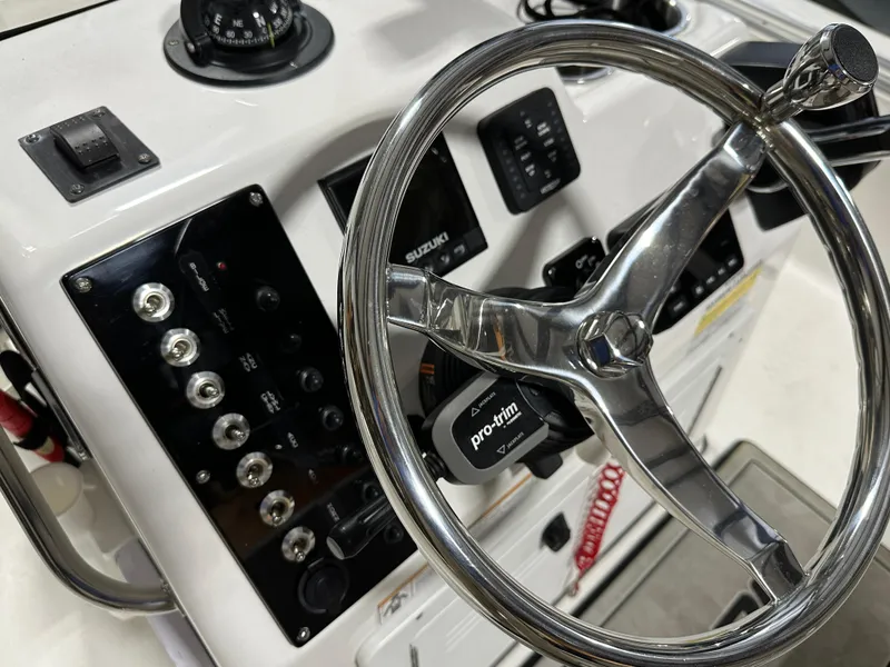 Slide: The Image of 2024 Sea Pro 172 Bay boat steering console with controls and gauges. - 8