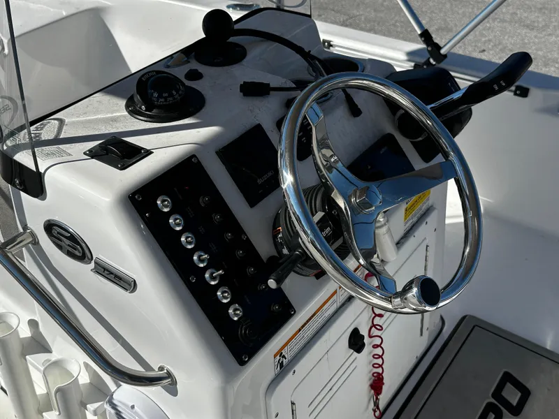Slide: The Image of 2024 Sea Pro 172 Bay boat console with steering wheel and control panel. - 9