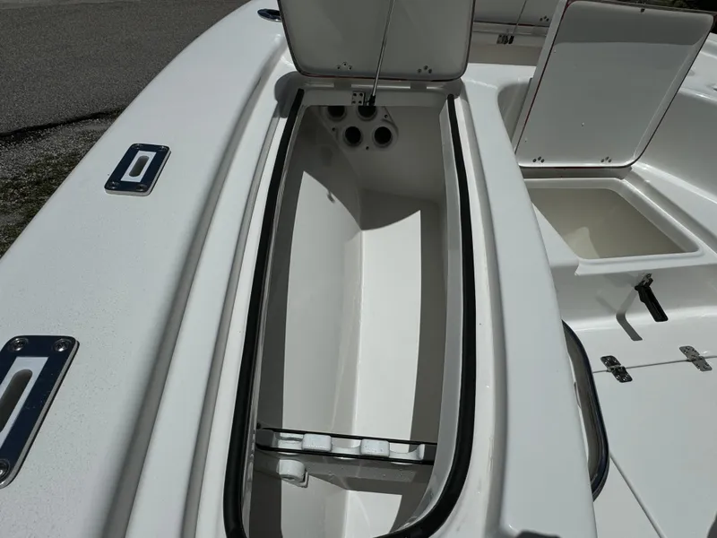 Slide: The Image of 2024 Sea Pro 230 Bay boat storage compartments with open hatches. - 11