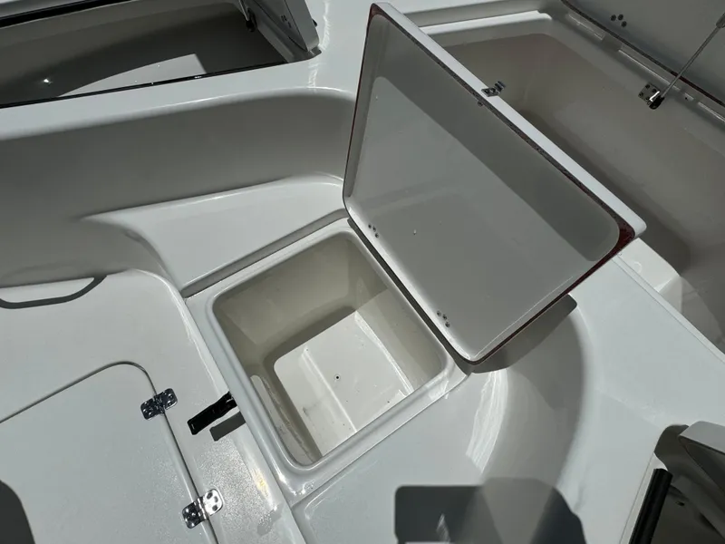 Slide: The Image of 2024 Sea Pro 230 Bay boat storage compartment with open lid. - 12