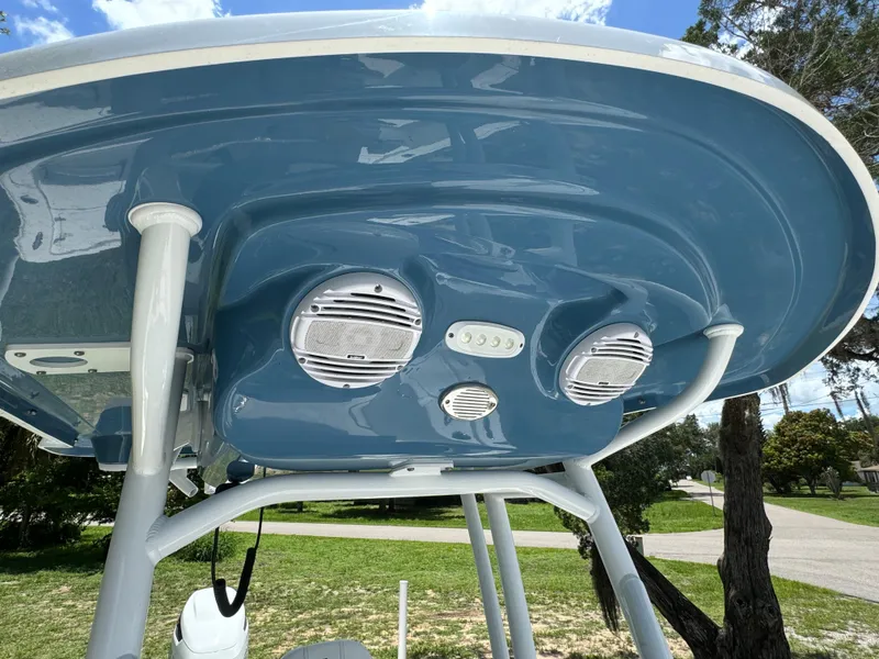 Slide: The Image of 2024 Sea Pro 230 Bay boat with blue T-top and speakers. - 19