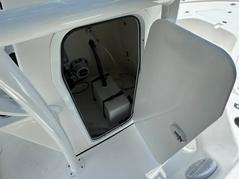 Slide: The Image of 2024 Sea Pro 230 Bay storage compartment with open door. - 21