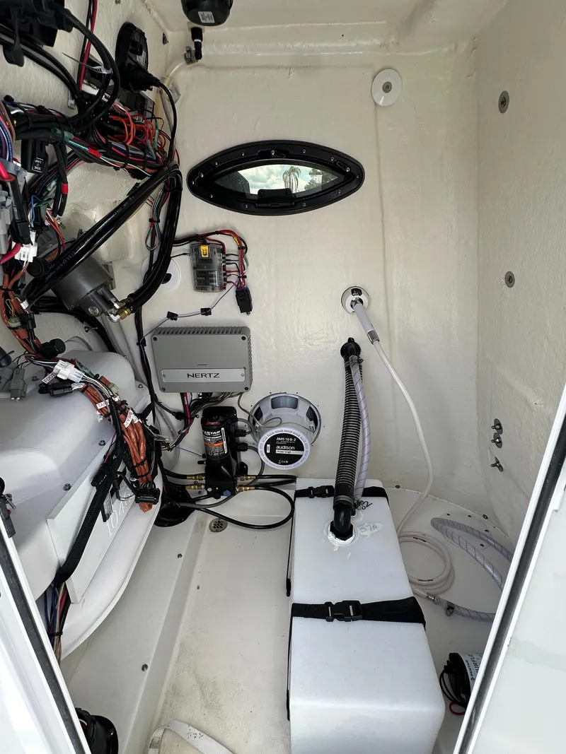Slide: The Image of 2024 Sea Pro 230 Bay boat interior wiring and equipment compartment. - 23
