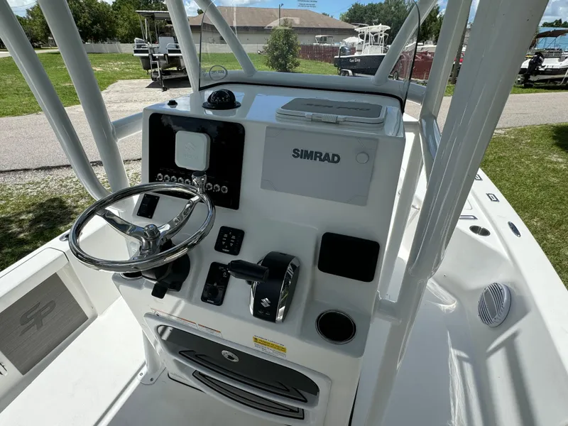 Slide: The Image of 2024 Sea Pro 230 Bay boat console with Simrad electronics and steering wheel. - 25