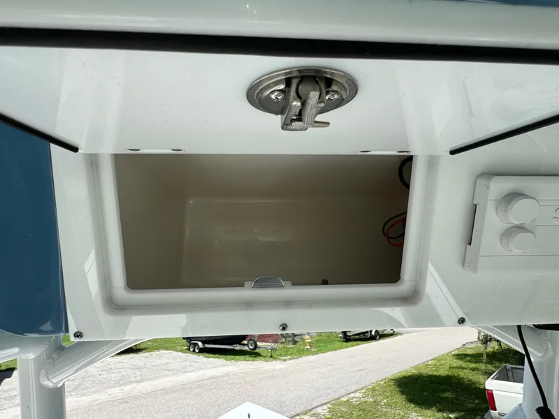 Slide: The Image of 2024 Sea Pro 230 Bay boat storage compartment with latch. - 31