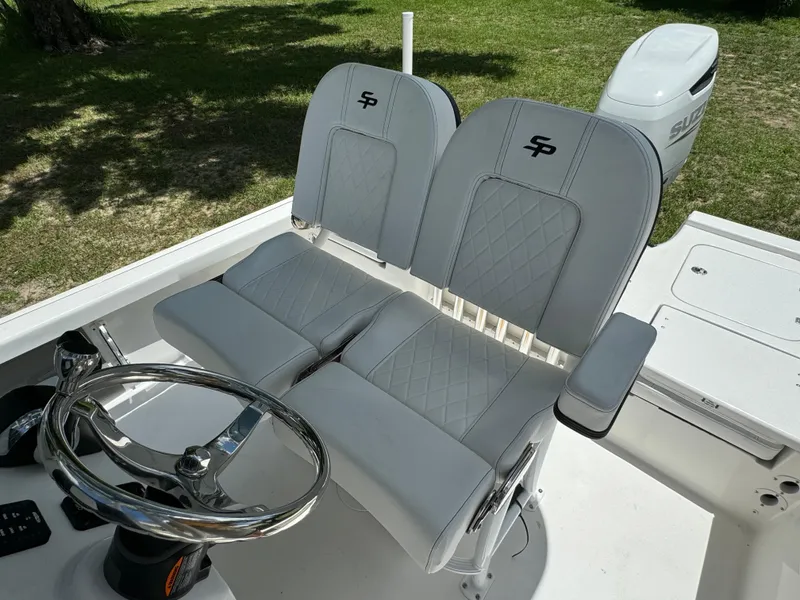 Slide: The Image of 2024 Sea Pro 230 Bay boat with dual captain's chairs and steering wheel. - 35