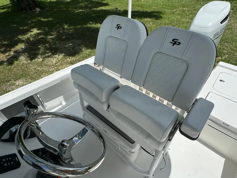 Slide: The Image of 2024 Sea Pro 230 Bay boat helm with dual seats and steering wheel. - 36