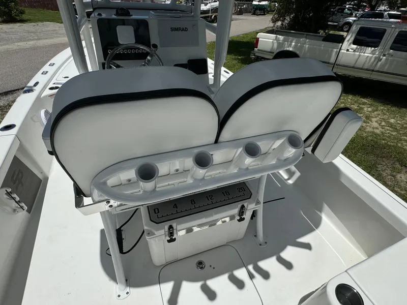 Slide: The Image of 2024 Sea Pro 230 Bay boat interior with dual seats and rod holders. - 37