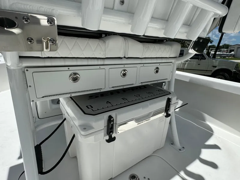 Slide: The Image of 2024 Sea Pro 230 Bay boat storage compartments and cooler. - 38