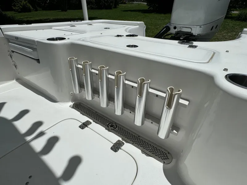 Slide: The Image of 2024 Sea Pro 230 Bay boat deck with rod holders and storage compartments. - 40