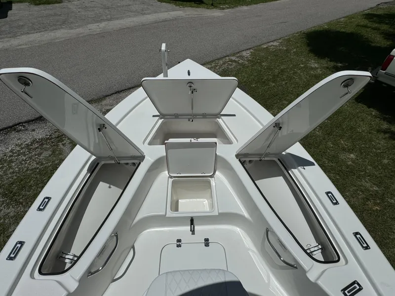 Slide: The Image of 2024 Sea Pro 230 Bay boat with open storage compartments. - 9