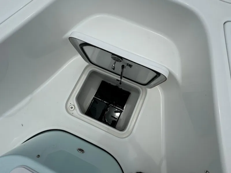 Slide: The Image of 2024 Sea Pro 210 Bay boat storage compartment with open hatch. - 10