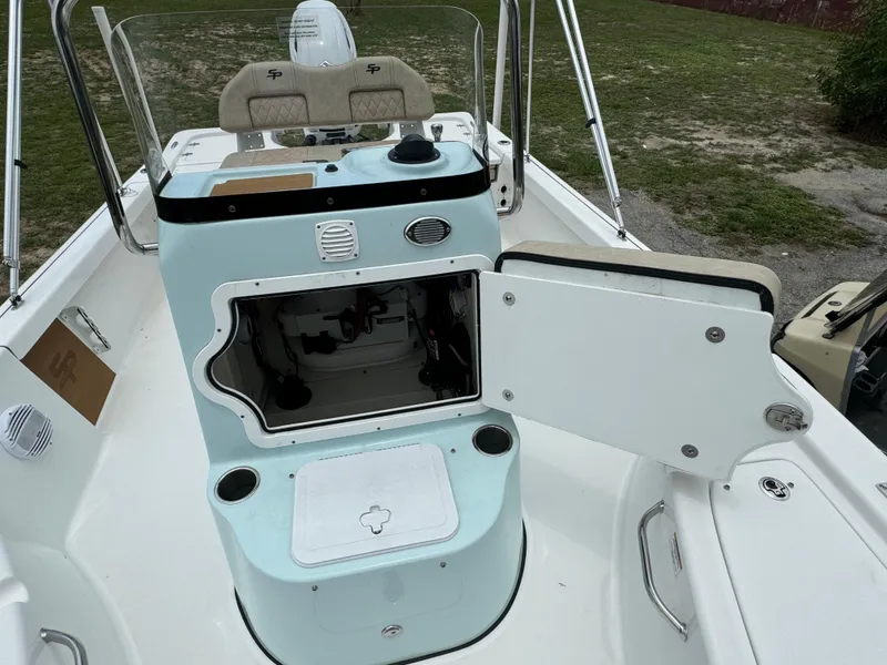 Slide: The Image of 2024 Sea Pro 210 Bay boat interior with open storage compartment. - 13