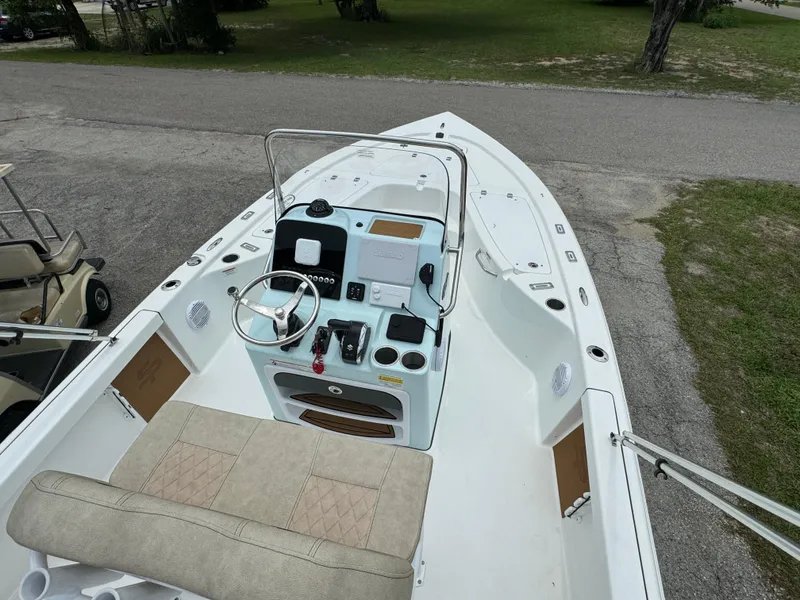 Slide: The Image of 2024 Sea Pro 210 Bay boat interior with steering console and seating. - 15