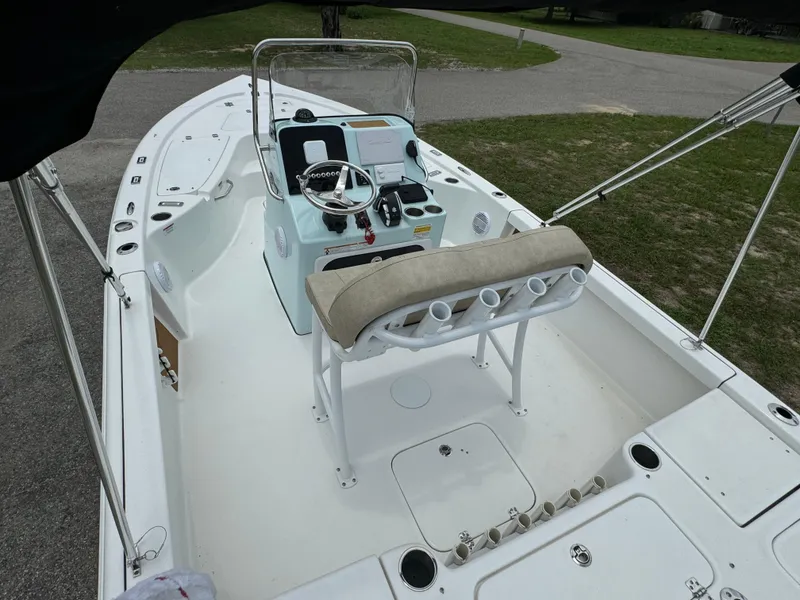 Slide: The Image of 2024 Sea Pro 210 Bay boat interior with center console and cushioned seating. - 16
