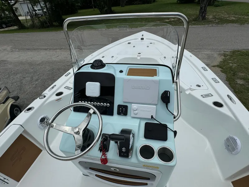 Slide: The Image of 2024 Sea Pro 210 Bay boat console with steering wheel and controls. - 17