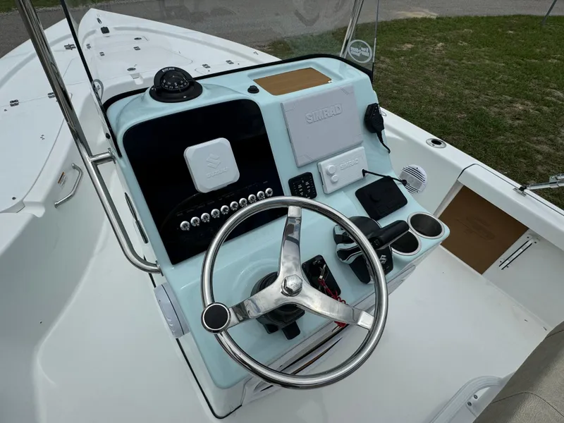 Slide: The Image of 2024 Sea Pro 210 Bay boat console with steering wheel and controls. - 18