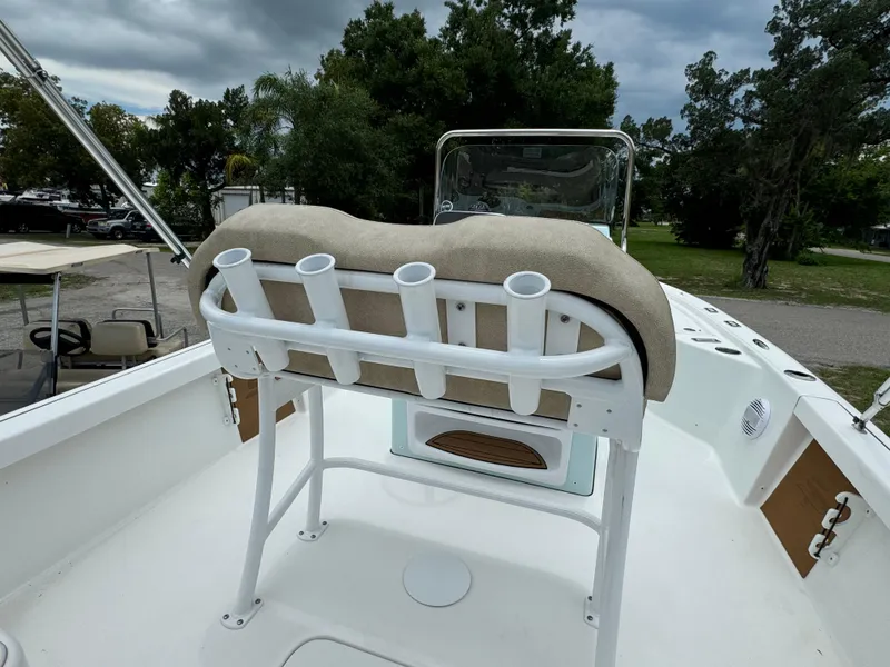 Slide: The Image of 2024 Sea Pro 210 Bay boat with rod holders and cushioned seating. - 24