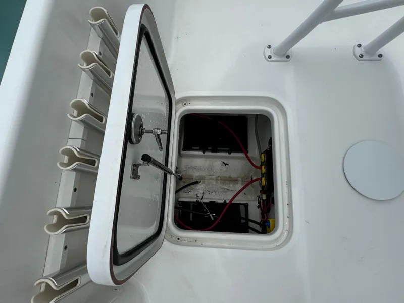 Slide: The Image of Open hatch on 2024 Sea Pro 210 Bay boat showing internal wiring and storage. - 29