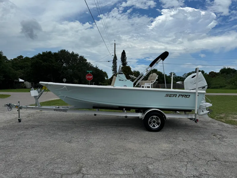 Slide: The Image of 2024 Sea Pro 210 Bay boat on a trailer under a cloudy sky. - 3