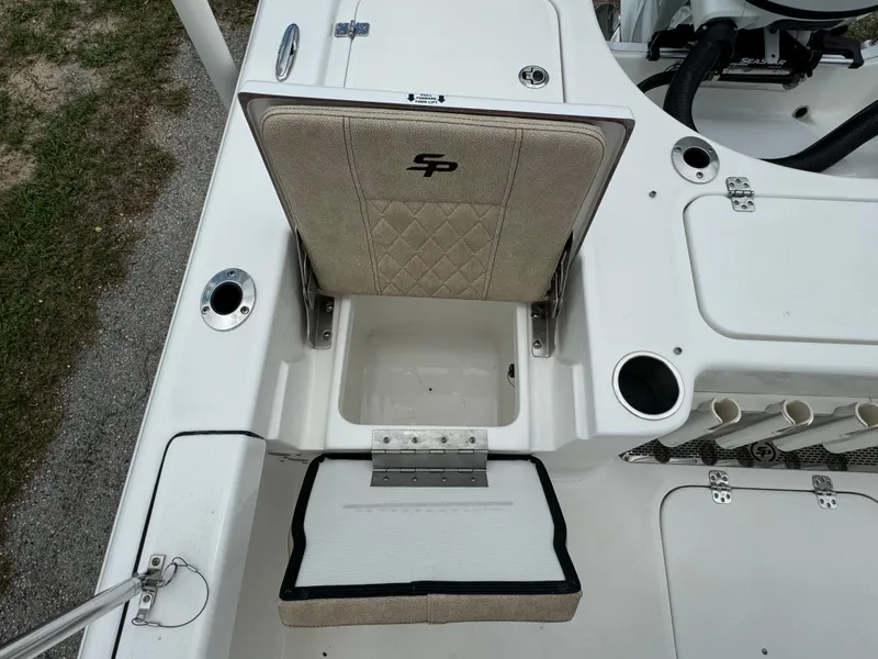 Slide: The Image of 2024 Sea Pro 210 Bay boat with open storage compartment and cushioned seat. - 30