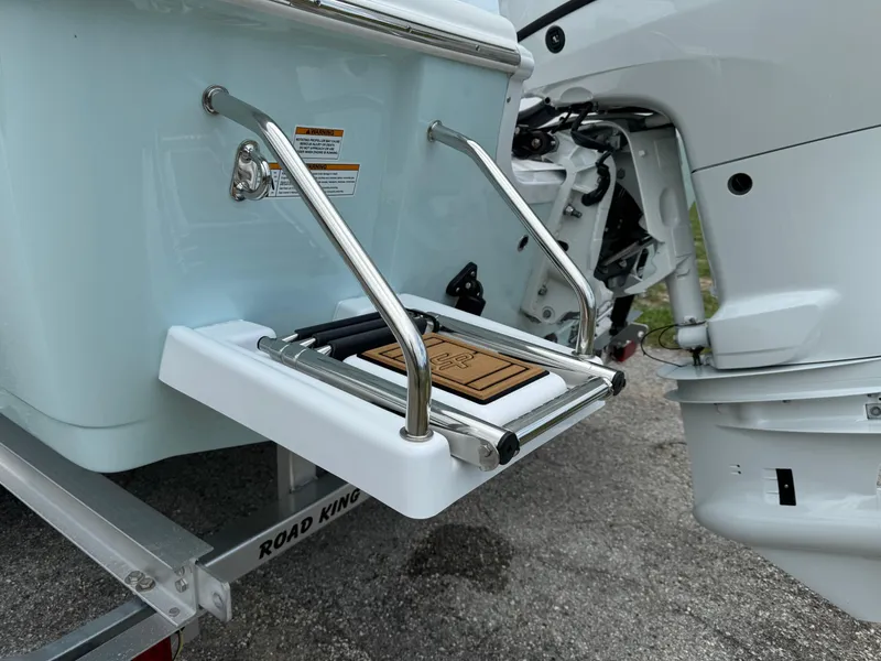 Slide: The Image of 2024 Sea Pro 210 Bay boat with a foldable swim ladder and outboard motor. - 36