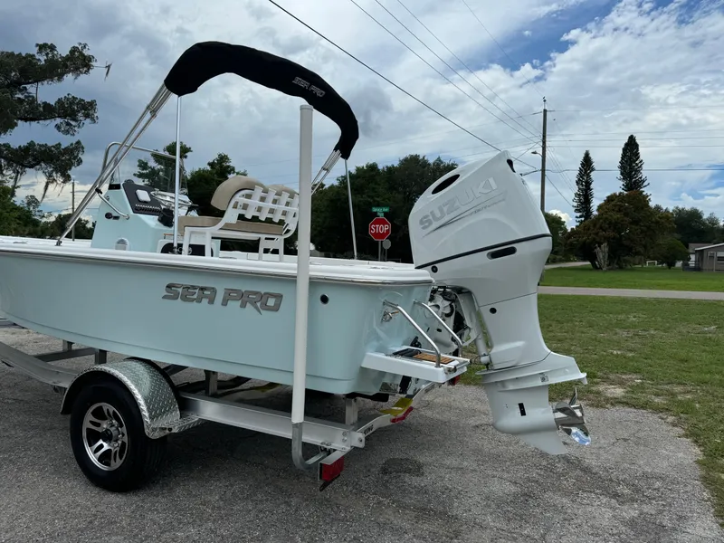 Slide: The Image of 2024 Sea Pro 210 Bay boat on trailer with Suzuki outboard motor. - 38