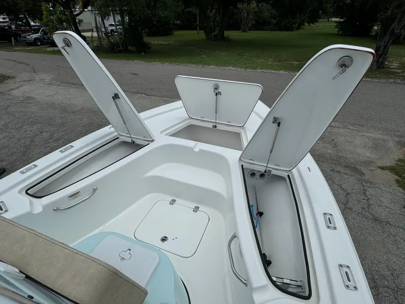 Slide: The Image of 2024 Sea Pro 210 Bay boat with open storage compartments. - 5