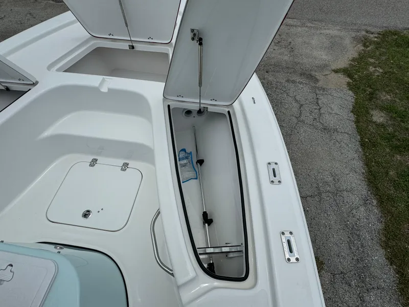 Slide: The Image of 2024 Sea Pro 210 Bay boat with open storage compartments. - 6