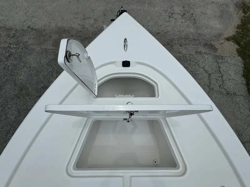 Slide: The Image of 2024 Sea Pro 210 Bay boat with open storage compartments. - 7