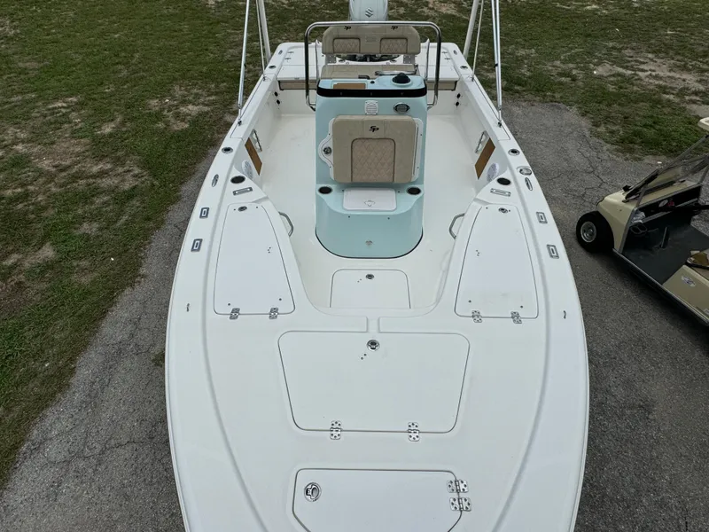 Slide: The Image of 2024 Sea Pro 210 Bay boat, top view, white deck, seating, storage compartments. - 8