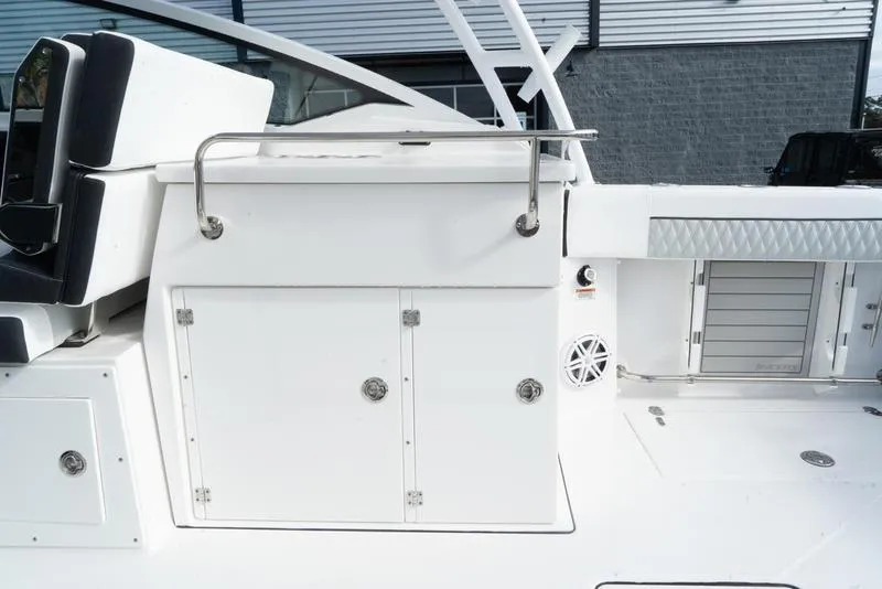 Slide: The Image of 2024 Blackfin 272 DC boat interior with storage compartments and seating. - 15