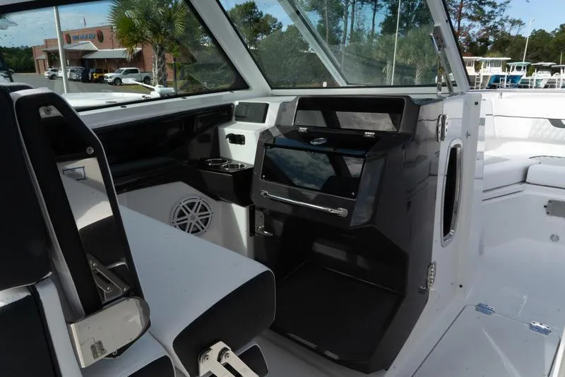 Slide: The Image of 2024 Blackfin 272 DC boat interior with modern dashboard and seating. - 16