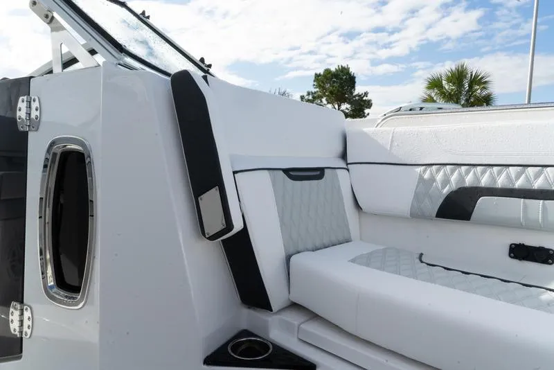 Slide: The Image of 2024 Blackfin 272 DC boat interior with white cushioned seating and modern design. - 18