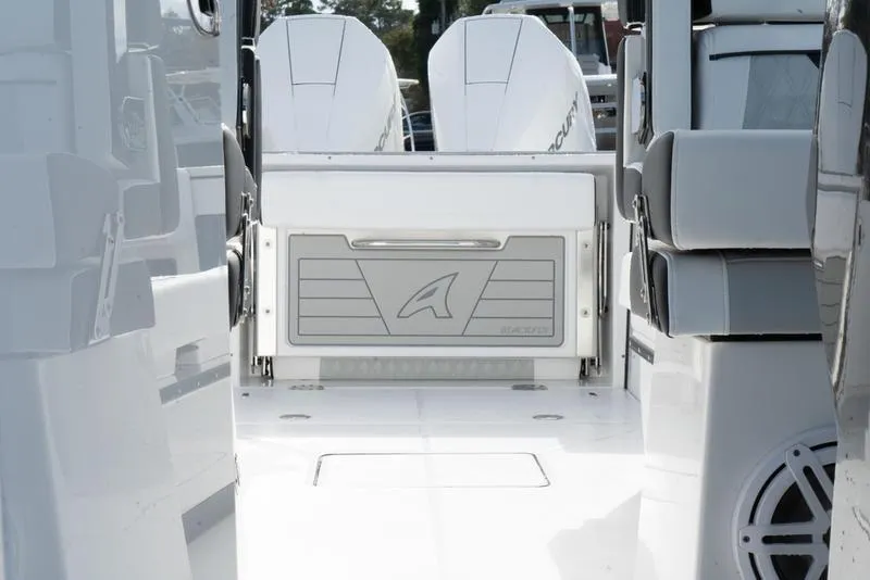 Slide: The Image of 2024 Blackfin 272 DC boat interior with dual engines and sleek design. - 19