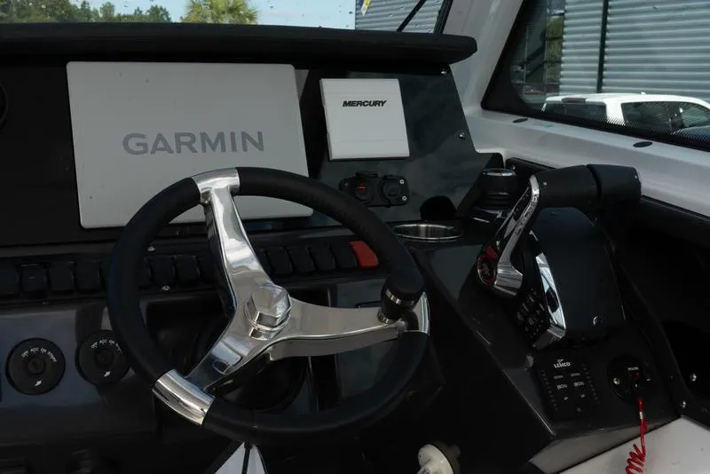 Slide: The Image of 2024 Blackfin 272 DC helm with Garmin and Mercury controls. - 22