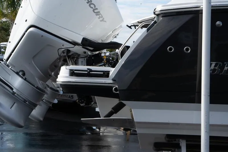 Slide: The Image of 2024 Blackfin 272 DC boat with Mercury outboard engines, docked in a marina. - 4
