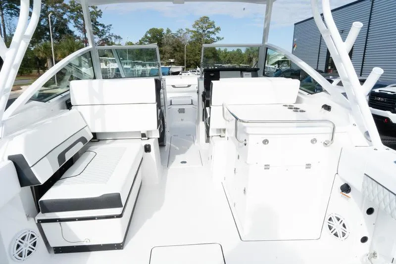 Slide: The Image of 2024 Blackfin 272 DC boat interior with white seating and modern design. - 7