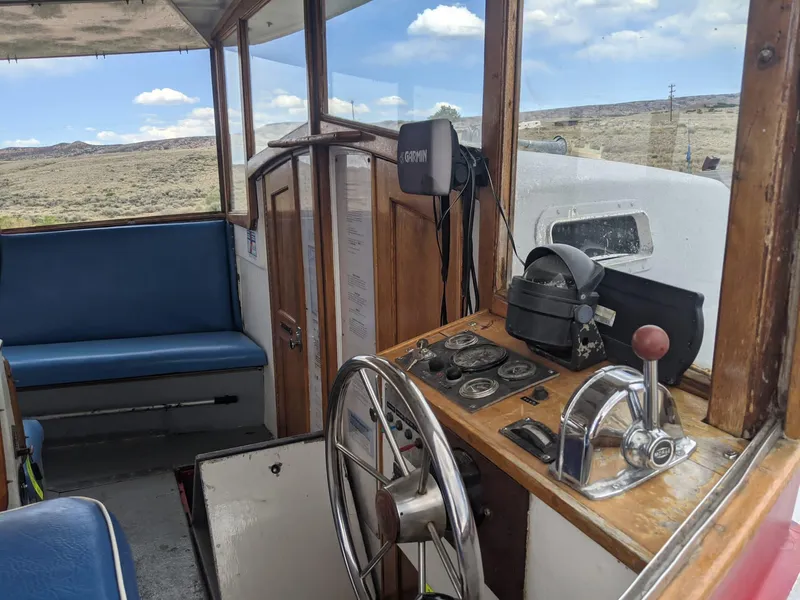 Slide: The Image of Interior of a 1987 custom tour boat with steering wheel and control panel. - 11