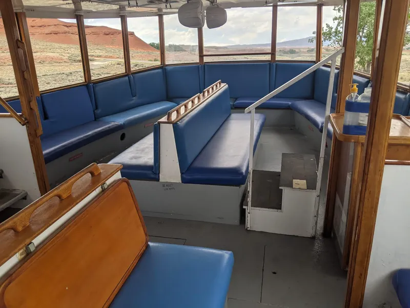 Slide: The Image of Interior of a 1987 Custom tour boat with blue seating and panoramic windows. - 12