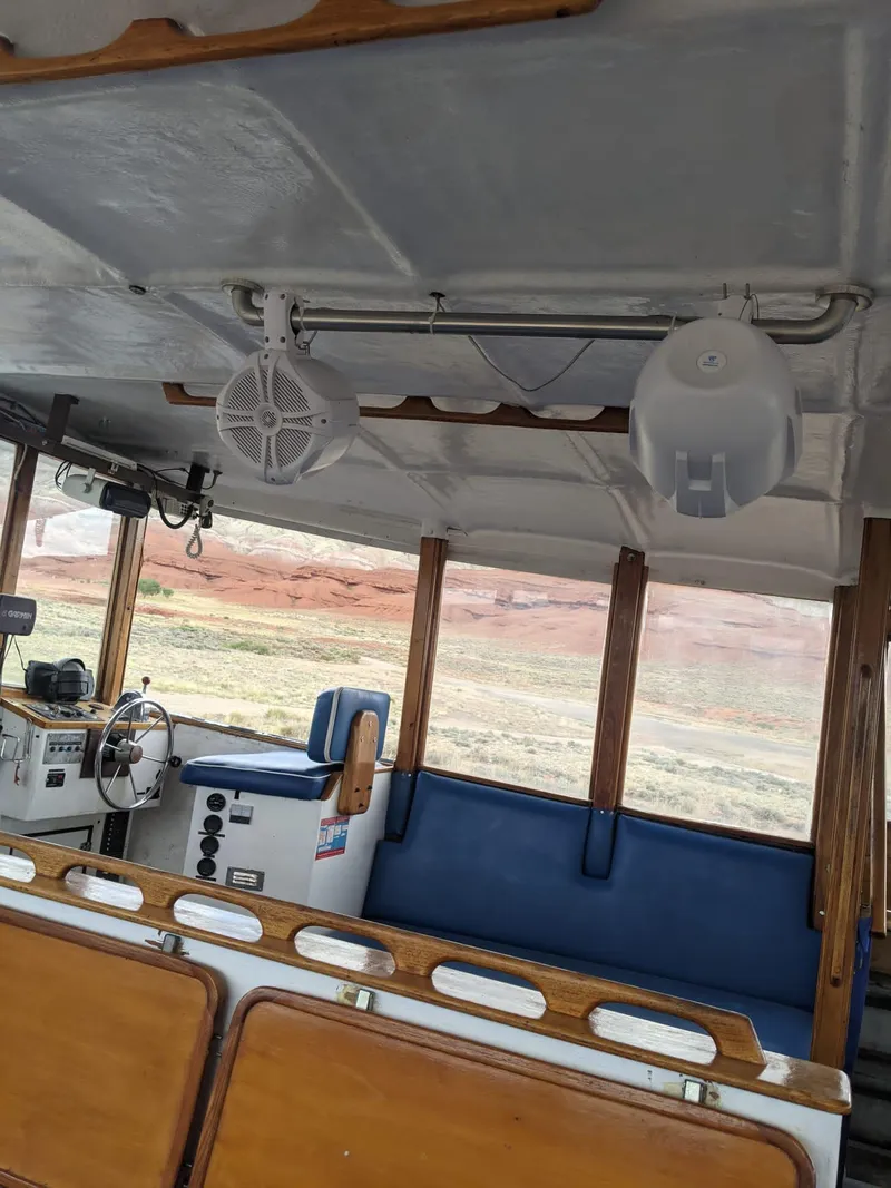 Slide: The Image of Interior of a 1987 Custom tour boat with seating and steering area. - 14