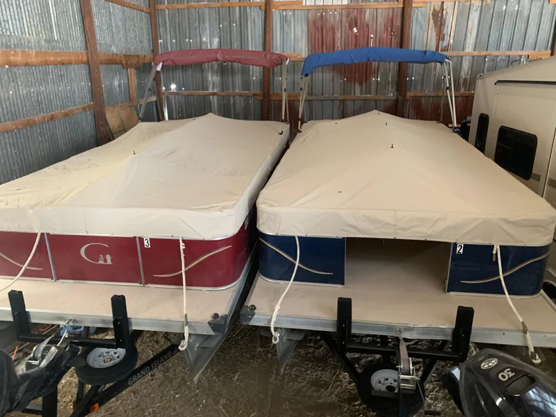 Slide: The Image of Two covered 1987 Custom tour boats stored in a metal shed. - 19