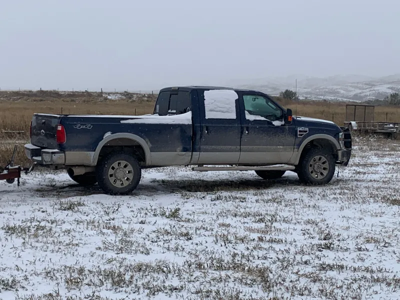 Slide: The Image of Blue pickup truck in snowy field, Custom Tour Boat and Business, 1987 model. - 26